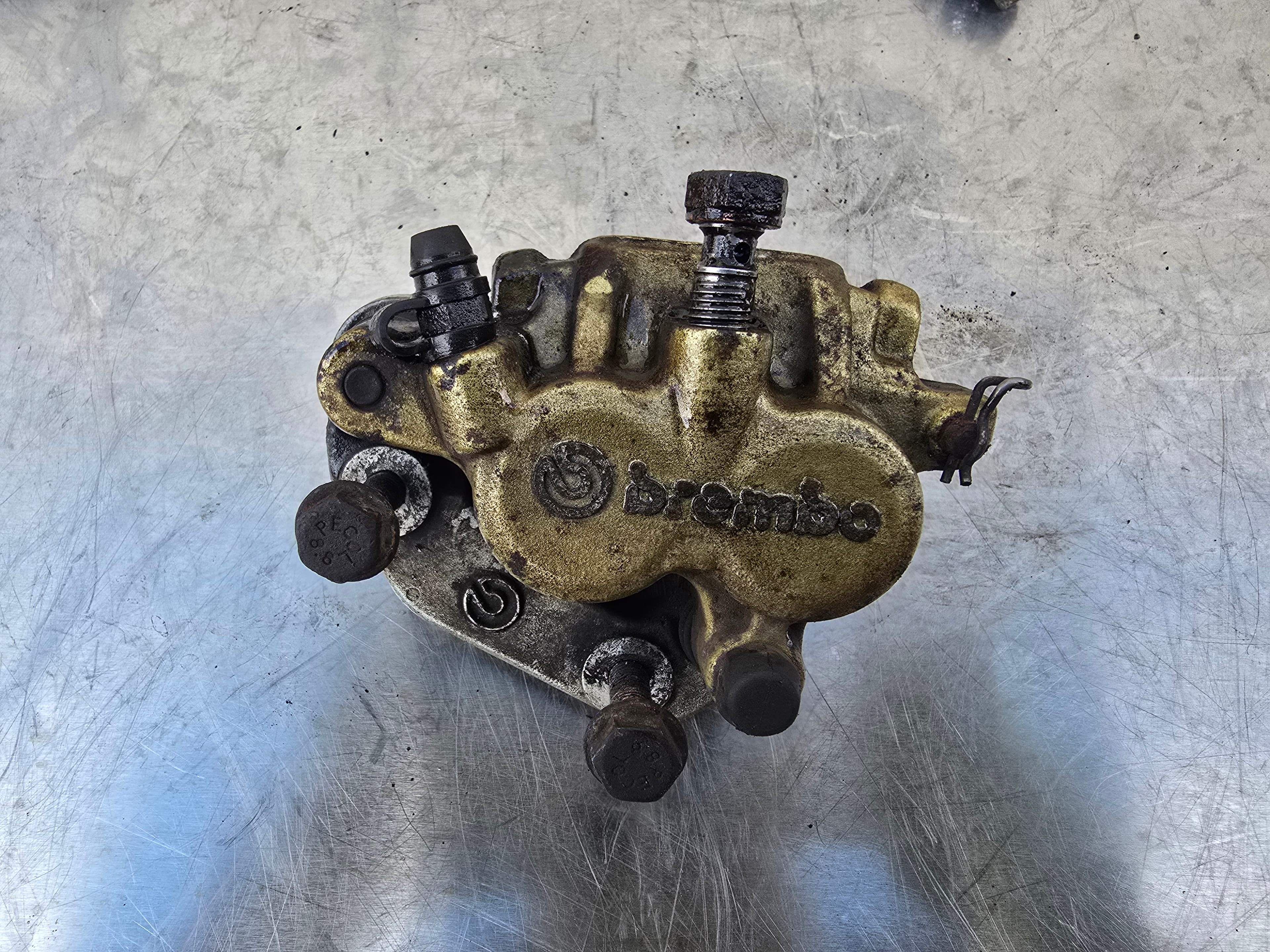 Top view of the Brembo front brake caliper showing the brand logo.